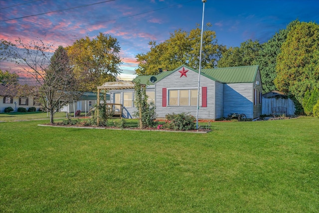 view of front of property with a shed and a lawn