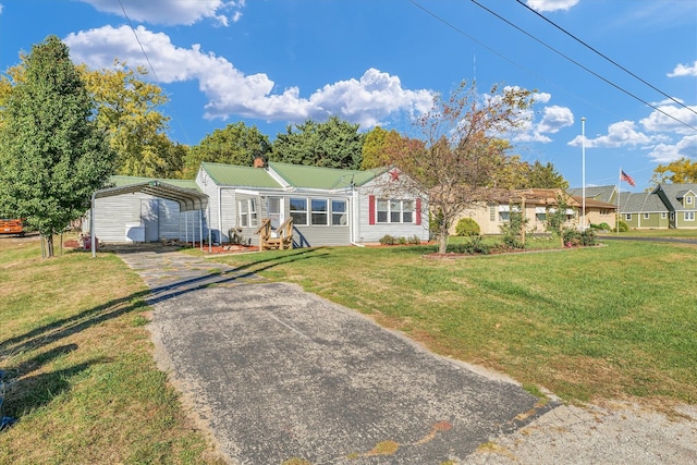 ranch-style house featuring a front yard and a carport