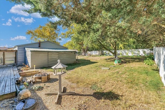 view of yard with a shed and a fire pit