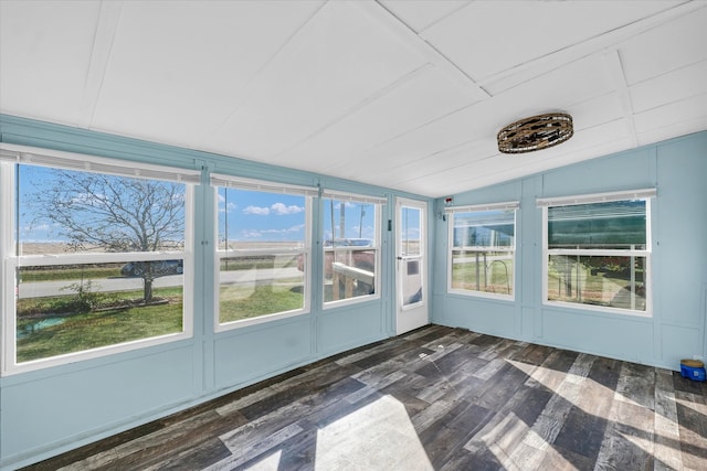 unfurnished sunroom featuring vaulted ceiling