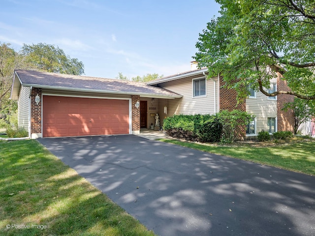 tri-level home featuring a front yard and a garage