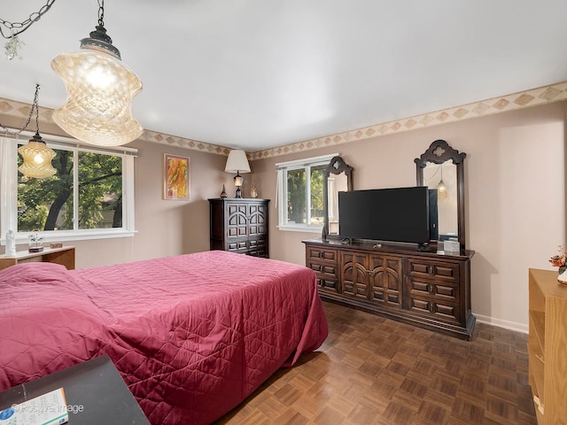 bedroom featuring dark parquet flooring