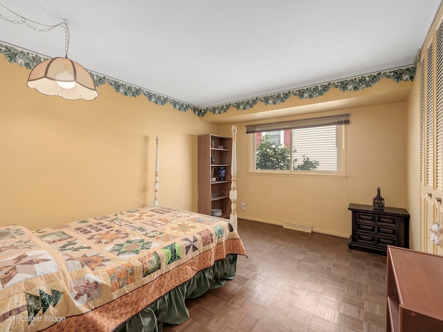 bedroom with parquet floors and a closet