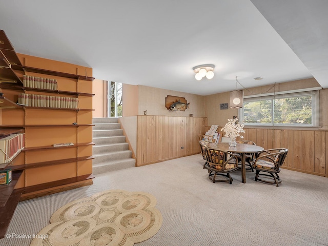 carpeted dining space with plenty of natural light