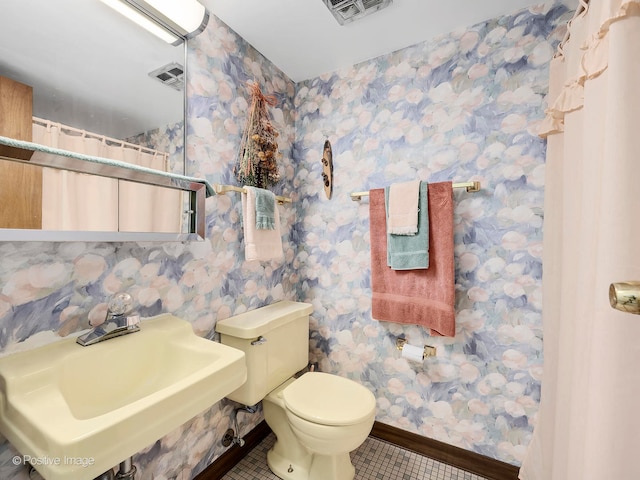 bathroom with sink, toilet, and tile patterned floors