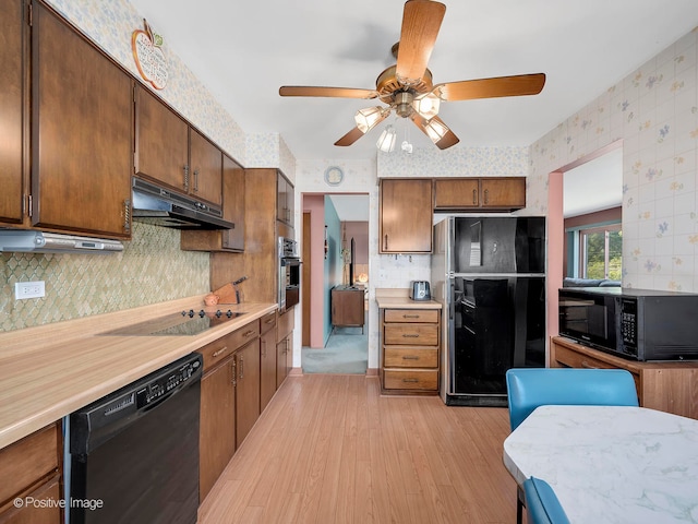 kitchen featuring light wood-type flooring, black appliances, and ceiling fan