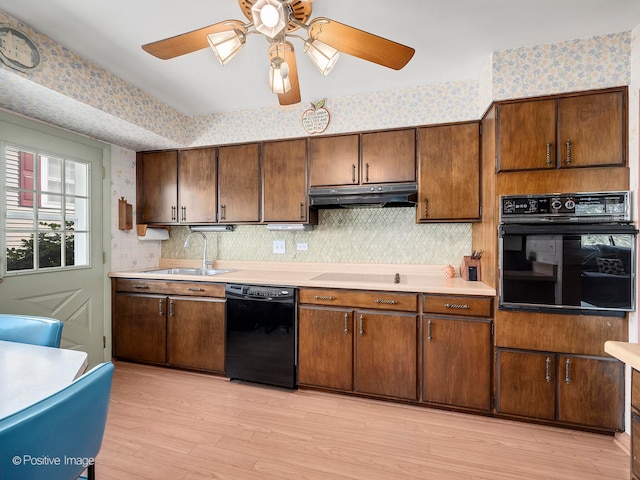 kitchen featuring black appliances, light hardwood / wood-style floors, sink, and ceiling fan