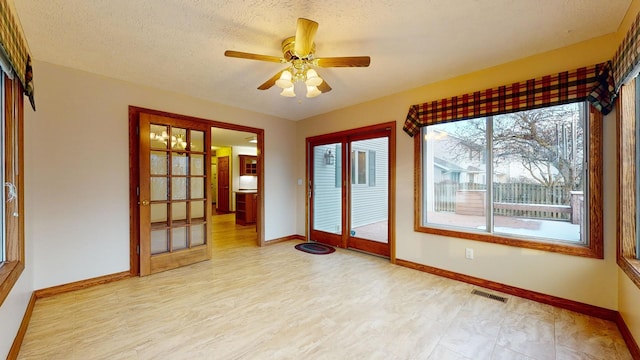 unfurnished sunroom with ceiling fan