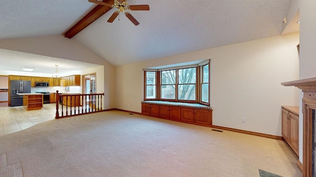 unfurnished living room with vaulted ceiling with beams, light carpet, and a textured ceiling