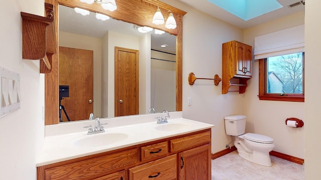 bathroom featuring tile patterned floors, vanity, and toilet