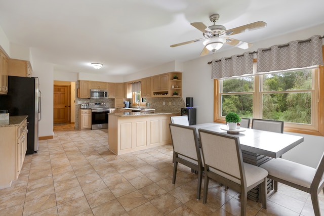 dining area with ceiling fan, light tile patterned flooring, and sink