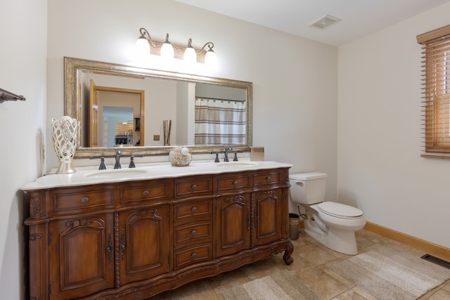 bathroom featuring tile patterned flooring, vanity, and toilet