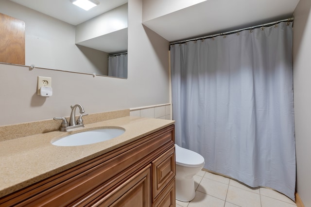 bathroom featuring walk in shower, tile patterned flooring, vanity, and toilet