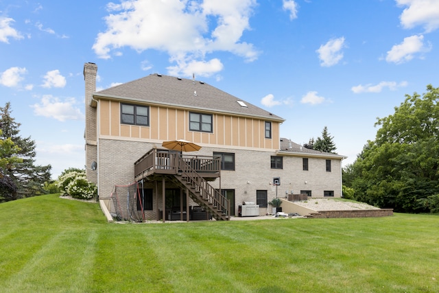 rear view of property with a wooden deck, a yard, and a patio area