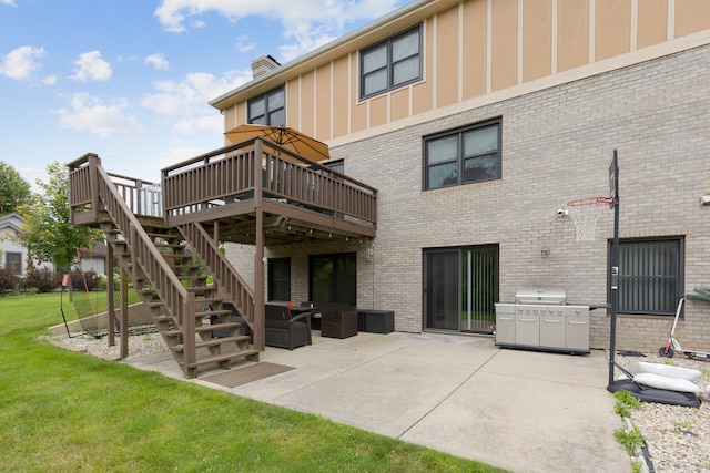 back of house with a deck, a lawn, and a patio area