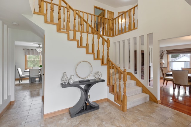 stairway with tile patterned floors and a wealth of natural light