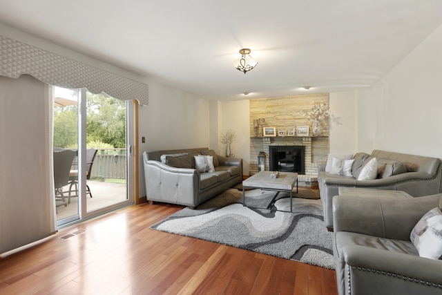 living room featuring light hardwood / wood-style flooring and a fireplace