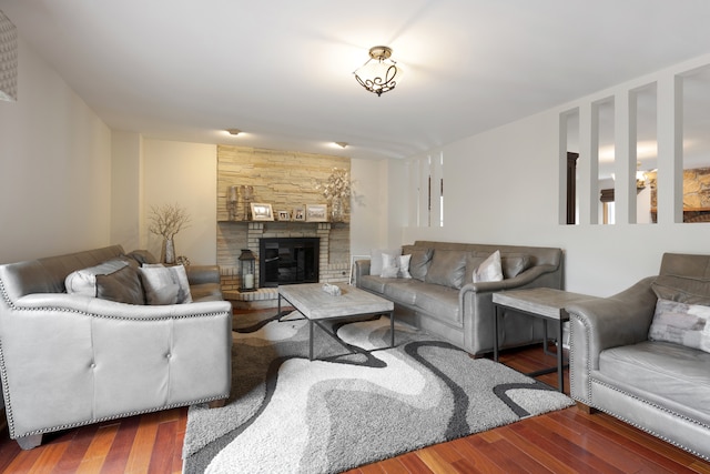 living room featuring dark hardwood / wood-style flooring and a large fireplace