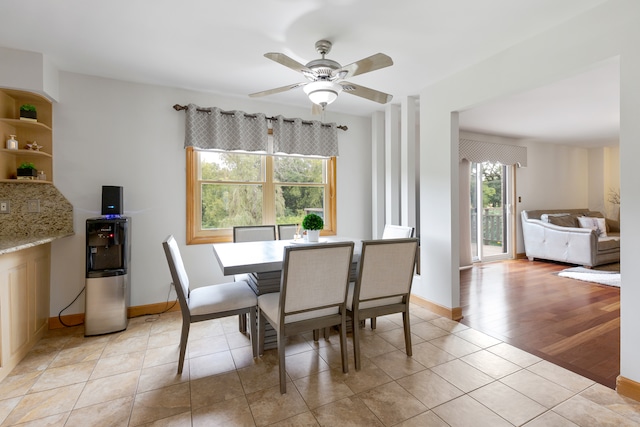 dining room with light wood-type flooring and ceiling fan