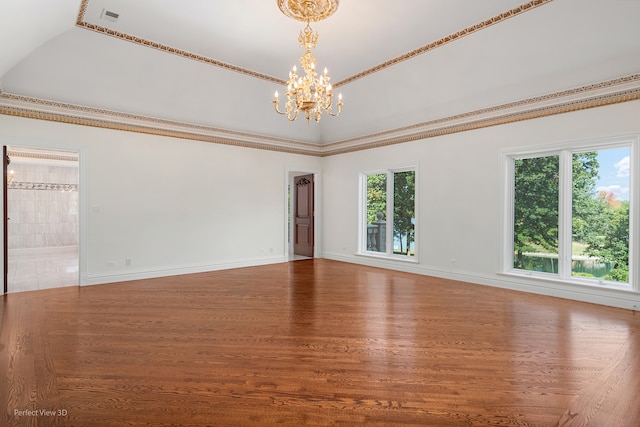 unfurnished room with wood-type flooring, an inviting chandelier, and plenty of natural light