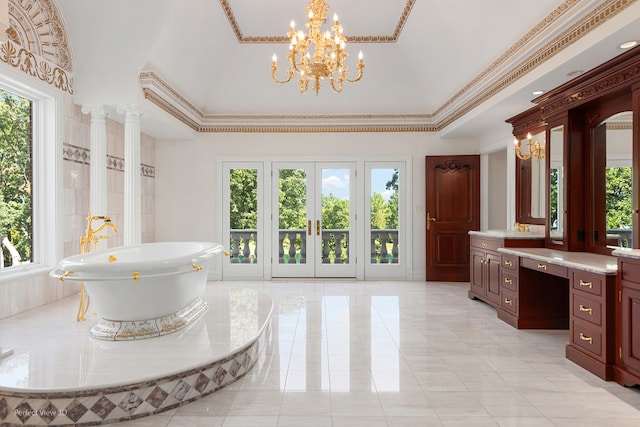 bathroom featuring crown molding, plenty of natural light, vanity, and a bathtub