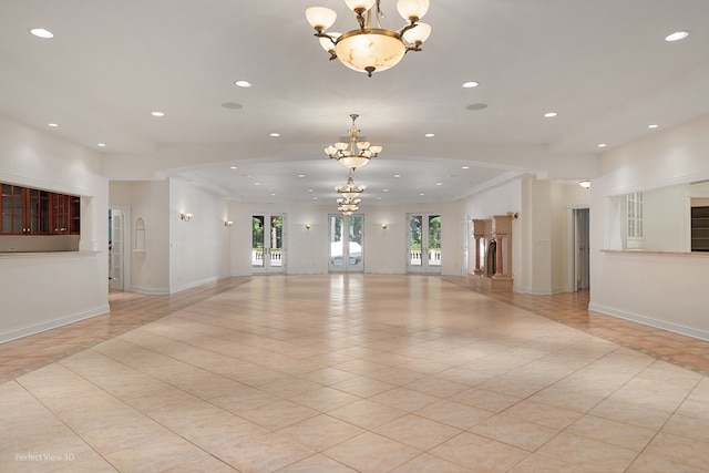 interior space with an inviting chandelier, light tile patterned floors, and french doors