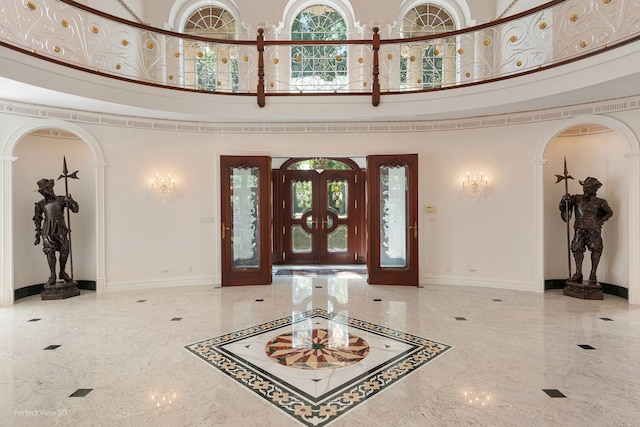 entryway with a high ceiling and a chandelier