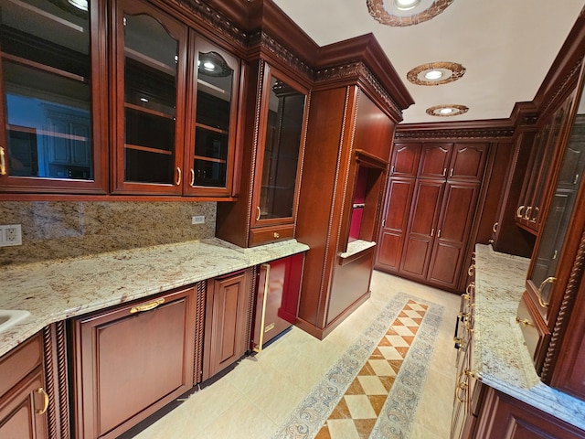 kitchen featuring light stone counters, backsplash, and light tile patterned floors