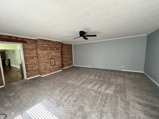 interior space featuring ceiling fan, a fireplace, ornamental molding, and dark carpet