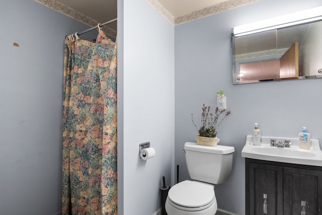 bathroom with vanity, toilet, and curtained shower