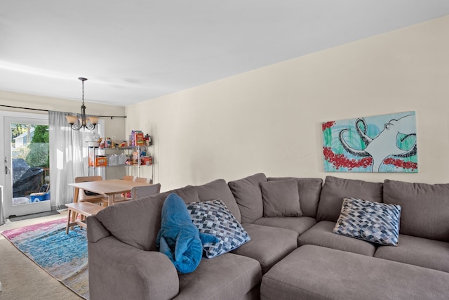 living room featuring carpet floors and a notable chandelier