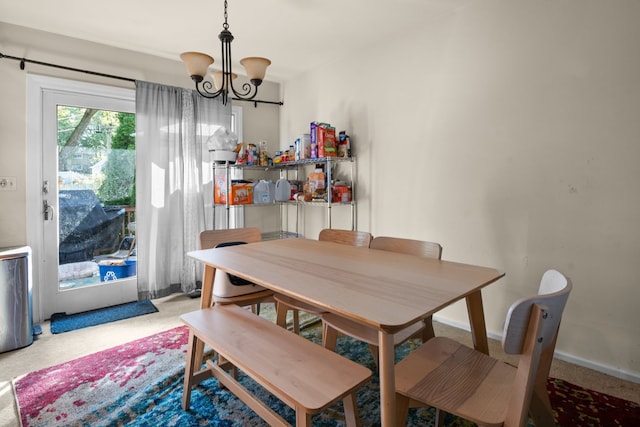 carpeted dining space with a notable chandelier