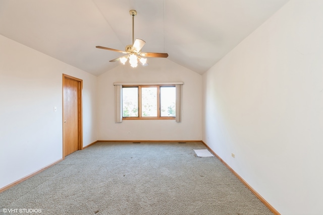 unfurnished room featuring lofted ceiling, ceiling fan, and carpet floors