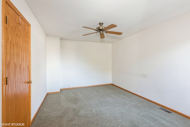 spare room with ceiling fan and carpet floors