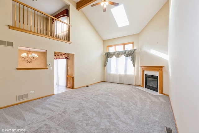 unfurnished living room with light carpet, a skylight, high vaulted ceiling, and a tile fireplace