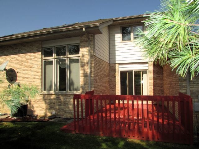 view of property exterior featuring a wooden deck