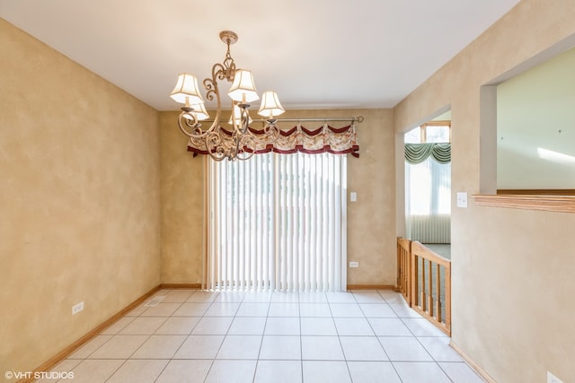 unfurnished dining area with tile patterned floors and an inviting chandelier