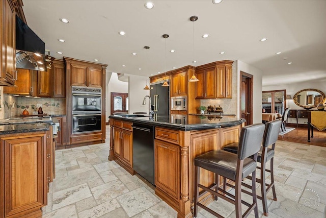 kitchen with recessed lighting, stone tile flooring, brown cabinetry, black appliances, and exhaust hood