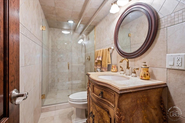 full bathroom featuring tile walls, a shower stall, toilet, and vanity