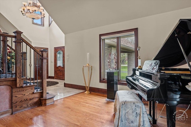 entrance foyer with light hardwood / wood-style floors and a chandelier