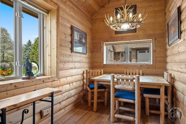 dining area featuring a chandelier, breakfast area, wood finished floors, and a wealth of natural light