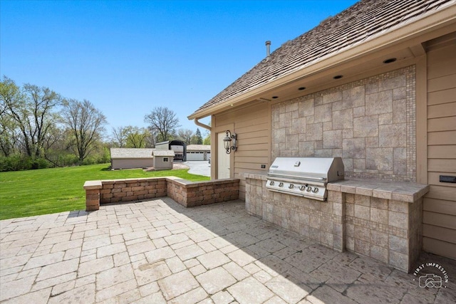 view of patio with area for grilling and an outdoor kitchen