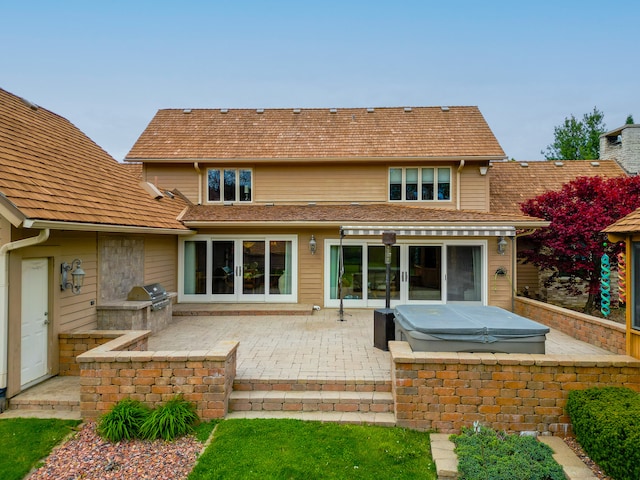 back of property with exterior kitchen, french doors, a patio, and a chimney