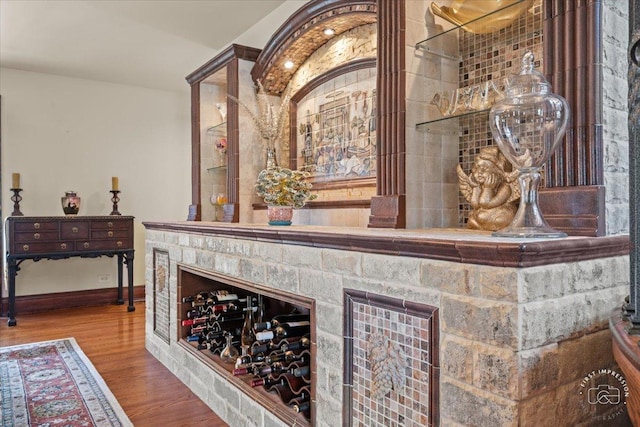 wine room featuring baseboards and wood finished floors