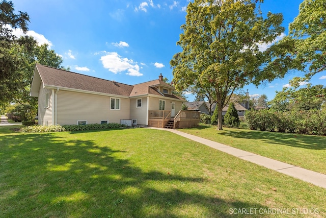 view of front of home with a wooden deck and a front lawn