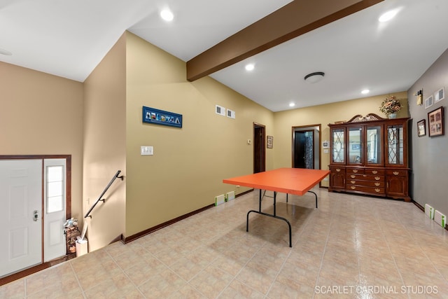 dining area with beamed ceiling and light tile patterned floors