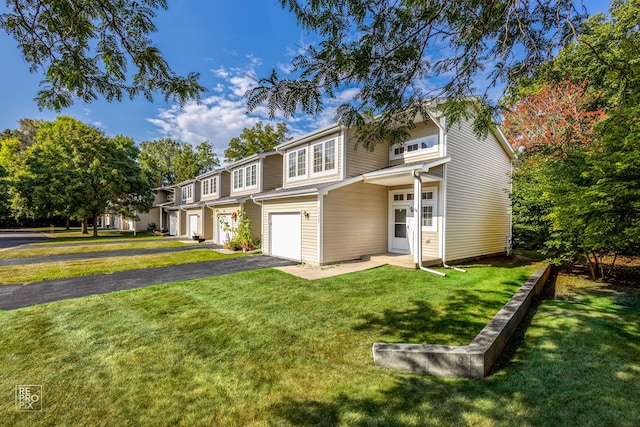 view of front of house with a garage and a front lawn