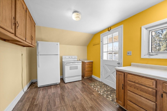 kitchen featuring lofted ceiling, dark hardwood / wood-style flooring, and white appliances