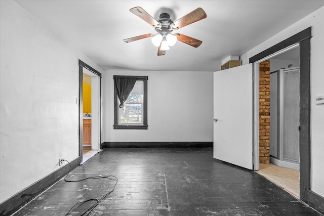 empty room with ceiling fan and dark hardwood / wood-style floors