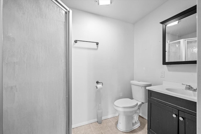 bathroom featuring vanity, toilet, and an enclosed shower